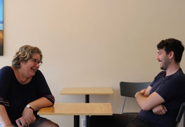 a man and woman sitting at a table at capital city mission