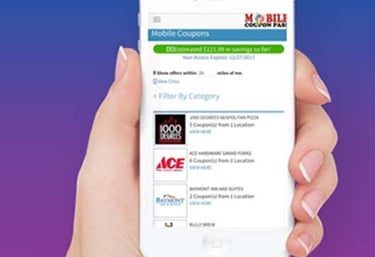 a person holding a phone with mobile coupons on it