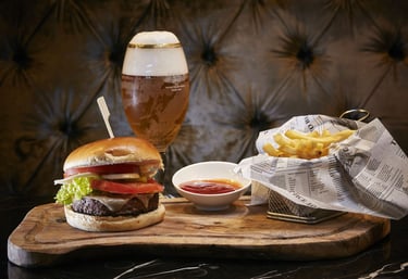Burger & Fries – Classic burger, fries, and beer in a stylish setting.
