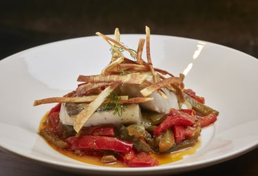 Seafood Dish – Fresh fish with roasted peppers and crispy potatoes.