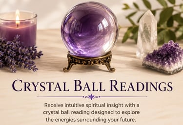 A purple crystal ball on a brass stand surrounded by amethyst, quartz, and lavender for spiritual readings.