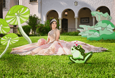 a woman sitting on a blanket in a garden quinceanera