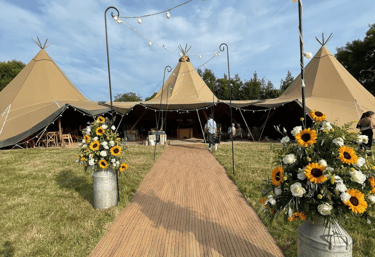 Wedding tent outside with sunflowers