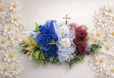 Red, white, and blue floral funeral arrangement with a gold cross for a patriotic memorial service.