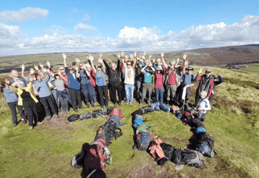 Walkers waving hands in the air to celebrate