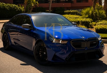 Luxury blue BMW M5 sedan parked at a luxury resort in Marbella for premium car rental services.