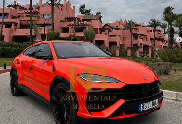 Bright orange Lamborghini Urus luxury SUV parked at a Marbella resort for high-end car rentals.
