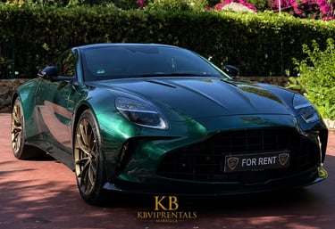 A luxury green Aston Martin Vantage for rent with gold rims parked outdoors in Marbella.