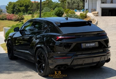 Black Lamborghini Urus luxury SUV available for rent in Marbella parked on a sunny driveway.