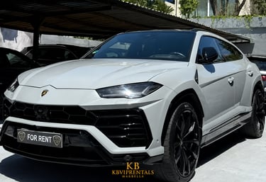 Luxury grey Lamborghini Urus SUV available for rent in Marbella, featuring black rims and sleek design.