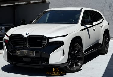 A white BMW XM luxury SUV with black trim parked at KB VIP Rentals in Marbella.