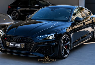 Black Audi RS5 Sportback luxury car rental in Marbella with sleek design and alloy wheels.