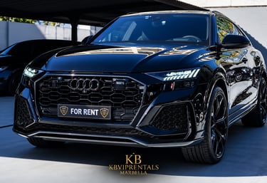 Luxury black Audi RS Q8 rental car parked in Marbella with sleek LED headlights and blacked-out grille.