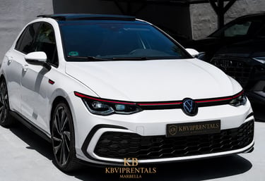 White Volkswagen Golf GTI luxury rental car parked at KB VIP Rentals in Marbella.