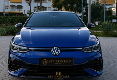 Front view of a blue Volkswagen Golf R parked in Marbella, featuring a luxury rental car logo.