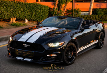 Black Ford Mustang convertible with white racing stripes available for luxury car rental in Marbella.