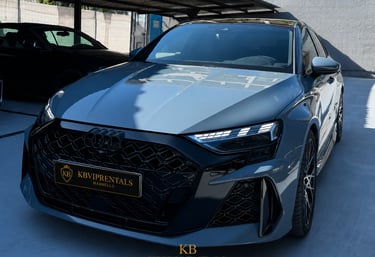 Luxury grey Audi RS3 sedan rental in Marbella with black honeycomb grille and LED headlights.