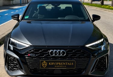 Front view of a dark grey Audi RS3 luxury car rental in Marbella with a honeycomb grille.