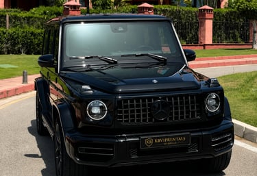 Luxury black Mercedes-Benz G-Class SUV parked at a premium car rental in Marbella.