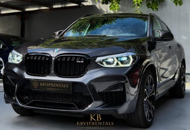 Luxury grey BMW X5 M rental car parked at KB VIP Rentals Marbella showroom.