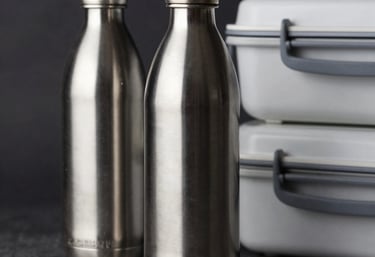 Close-up of premium, sleek stainless steel bottles and modern lunch boxes in a professional studio setting, reflecting quality and durability for global distribution.