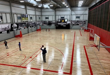 a man standing on a basketball court with a ball