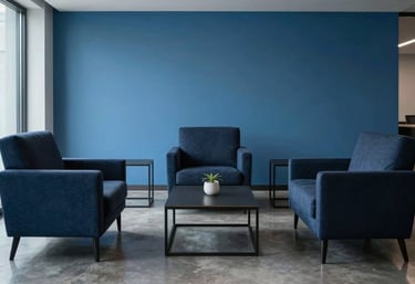 A minimalist North American / US office lounge with high-end furniture. The room is decorated in Dark Navy and Alice Blue tones, reflecting a professional atmosphere.