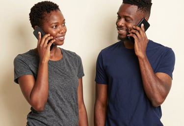 Friendly shop assistant answering a phone call in a cozy store environment.