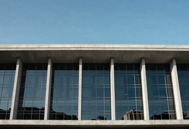 A minimalist architectural view of a modern legal building in Brazil with glass panels reflecting a clear blue sky. Symbolizes stability and modern law.