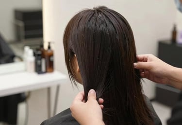 A serene close-up of a woman receiving a luxurious facial treatment in a bright, minimalist spa room.