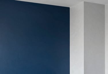 Modern interior space with professional painting finishes, featuring a dark blue accent wall and clean grey transitions, North American architectural style, sharp and clean lines.