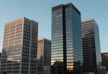 A group of modern South American / Brazilian office buildings against a clear sky, reflecting soft sky blue tones.