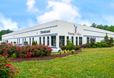 Modern white commercial office building for Young Office and Steelcase with red roses in the foreground.