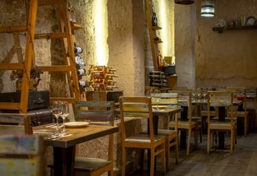 Rustic Tapastan restaurant interior with wooden tables, wine racks, and warm ambient lighting.