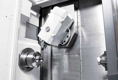 Precision 5-axis CNC milling machine spindle performing automated industrial metal machining.