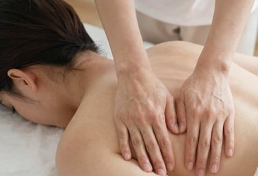 A serene spa room with soft lighting and a massage table ready for a relaxing body massage.