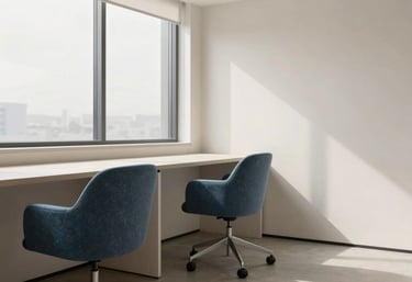 Modern minimalist office interior with slate blue chairs, a large window, and clean soft off-white surfaces. Natural lighting.