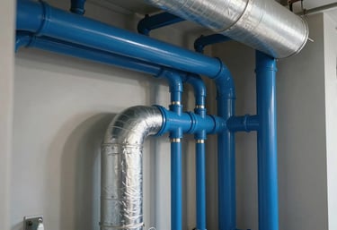 A clean, well-maintained residential mechanical room in a North American / US home, featuring royal blue pipes and silver HVAC ductwork.
