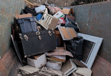 miscellaneous items in dumpster bin