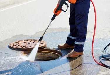 a man in a blue overalls is using a pressurer