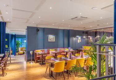 a restaurant with a large table and chairs