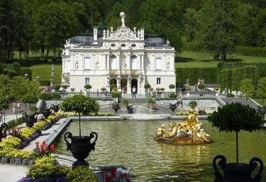 Linderhof Palace in Bavaria featuring golden fountain and ornate architecture in the formal gardens.