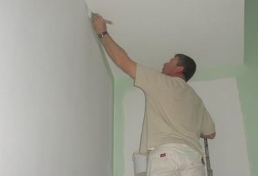 Professional painter applying wall paint in Boise home - Golden Hands Painting expert team