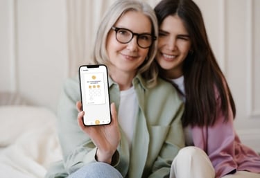 a woman holding a cell phone with a digital loyalty card