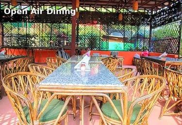 Outdoor dining area at Jungle Lore Resort with bamboo seating