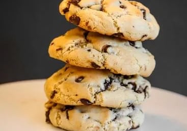 a stack of cookies and chocolate chip cookies on a cake plate