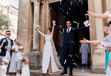 a bride and groom are standing in front of a crowd of people