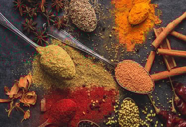 a variety of spices cumin staranish coriander are scattered on a table