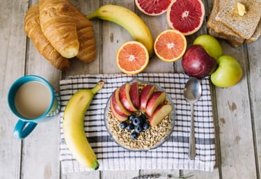 a breakfast of fruit and bread on a table