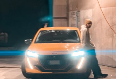 a man standing in front of a car with a light on it